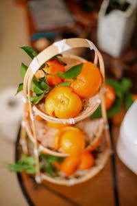 Vibrant oranges arranged in a bamboo basket adding a fresh touch.